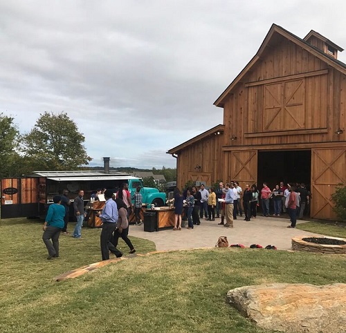 Windy Hill Event barn with crowd of people spilling out of open doors next to a food truck